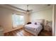 Comfortable bedroom with ceiling fan, window, and bedside table at 10048 Cleghorn Dr, San Antonio, FL 33576