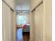 View into bedroom featuring a large window, ceiling fan, and wood flooring at 10048 Cleghorn Dr, San Antonio, FL 33576