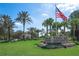Tampa Bay Golf and Country Club entrance with palm trees and American flag at 10048 Cleghorn Dr, San Antonio, FL 33576