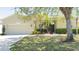 Charming single-story home with a well-maintained lawn and lush landscaping, offering inviting curb appeal at 10048 Cleghorn Dr, San Antonio, FL 33576