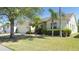 View of house featuring a well-maintained lawn and mature landscaping, enhancing its curb appeal at 10048 Cleghorn Dr, San Antonio, FL 33576