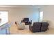 Open living room with cozy recliner seating and an entertainment system, perfect for relaxation and enjoyment at 10048 Cleghorn Dr, San Antonio, FL 33576