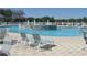 Community pool with multiple water features and comfortable lounge chairs on the pool deck at 10048 Cleghorn Dr, San Antonio, FL 33576