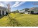A vast backyard with a manicured lawn and consistent landscaping at 1010 Mango Ct, Oldsmar, FL 34677