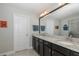 Well-lit bathroom featuring double sinks, granite countertops, and a walk-in shower at 1010 Mango Ct, Oldsmar, FL 34677