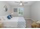 Cozy bedroom with a queen bed, neutral colors, and a bright window at 1010 Mango Ct, Oldsmar, FL 34677