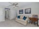 This bedroom offers carpet, neutral walls, ceiling fan, two framed pictures, and a table at 1010 Mango Ct, Oldsmar, FL 34677