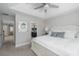 Serene bedroom with a tray ceiling, a view to the ensuite bathroom, and neutral decor at 1010 Mango Ct, Oldsmar, FL 34677