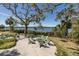 Community fire pit area with seating overlooking the water and bridge at 1010 Mango Ct, Oldsmar, FL 34677