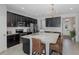 Stylish kitchen featuring granite countertops, stainless steel appliances, and dark cabinetry at 1010 Mango Ct, Oldsmar, FL 34677