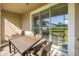 Outdoor patio with a dark wood table and chairs with sliding doors to the interior at 1010 Mango Ct, Oldsmar, FL 34677