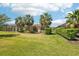Lush green backyard with mature landscaping and screened-in patio for outdoor enjoyment at 10612 Glencorse Ter, Bradenton, FL 34211