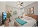 Cozy bedroom with nautical theme, large windows, a ceiling fan, and comfortable furnishings at 10612 Glencorse Ter, Bradenton, FL 34211