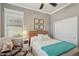 Inviting bedroom with comfy leather chair, white linens, and an ocean-themed decor at 10612 Glencorse Ter, Bradenton, FL 34211