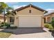 A tan home with a large two car garage and brick paver driveway at 10612 Glencorse Ter, Bradenton, FL 34211