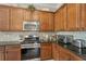 Stylish kitchen with a stainless steel stove and granite countertops at 10612 Glencorse Ter, Bradenton, FL 34211