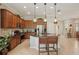 Spacious kitchen featuring dark cabinets, granite countertops, and stainless-steel appliances at 10612 Glencorse Ter, Bradenton, FL 34211