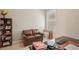 This office features a cozy leather loveseat, built-in bookcase, and a window with natural light at 10612 Glencorse Ter, Bradenton, FL 34211