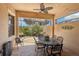 Inviting covered patio with elegant outdoor dining set, ceiling fan, and views of the greenery at 10612 Glencorse Ter, Bradenton, FL 34211