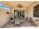 Charming covered patio with decorative dining table and chairs and view to interior of home at 10612 Glencorse Ter, Bradenton, FL 34211