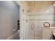 Elegant bathroom shower with glass door, tile surround, and decorative accent strip at 10612 Glencorse Ter, Bradenton, FL 34211
