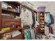 Spacious walk-in closet offering ample storage, wooden shelves, and hanging rods for organization at 10612 Glencorse Ter, Bradenton, FL 34211