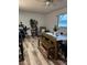 Bright dining room with wood-look floors and a rustic dining table at 1129 Forbes Trce, Tarpon Springs, FL 34689