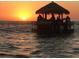 Floating tiki bar in the ocean at sunset for enjoying drinks with friends and unforgettable ocean memories at 1129 Forbes Trce, Tarpon Springs, FL 34689