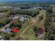 Aerial view of the home showcasing its location on a golf course with mature trees at 11719 Foxworth Ln, New Port Richey, FL 34654