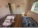 This bedroom has twin beds, hardwood floors and closets at 11803 127Th Ave, Largo, FL 33778