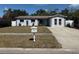 Charming single-story home with tidy landscaping, a well-manicured lawn, and traditional mailbox at 11803 127Th Ave, Largo, FL 33778