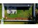 Aerial view showcases fully fenced backyard, patio, manicured landscaping, and outdoor amenities at 12140 74Th St, Largo, FL 33773