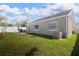 Well-maintained backyard features green grass, patio area, and privacy fence at 12140 74Th St, Largo, FL 33773