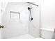 Modern shower featuring luxurious marble-style tile, recessed lighting, and a rainfall shower head at 12140 74Th St, Largo, FL 33773