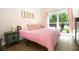 Comfortable bedroom with a large window, side tables, and natural light at 12140 74Th St, Largo, FL 33773