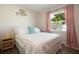 Inviting bedroom with a large window, stylish decor, and lots of natural light at 12140 74Th St, Largo, FL 33773