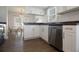 Bright kitchen features white cabinets, granite countertops, stainless steel appliances, and wood-look flooring at 12140 74Th St, Largo, FL 33773