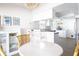 Kitchen with a breakfast bar, modern lighting, and white cabinets with stainless appliances at 12140 74Th St, Largo, FL 33773