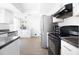 Clean kitchen featuring stainless steel appliances, and bright white cabinets with dark countertops at 12140 74Th St, Largo, FL 33773