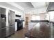 Spacious kitchen featuring stainless steel appliances, white cabinets, granite counters, and an adjacent dining area at 12140 74Th St, Largo, FL 33773