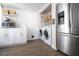 Utility area with a laundry closet, washer, dryer, white cabinets, and butcher block countertop at 12140 74Th St, Largo, FL 33773
