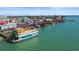 Aerial view of the town showing shops and restaurants, docks, and the abundance of water activities at 12924 Gulf Blvd # 502, Madeira Beach, FL 33708