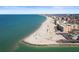 Breathtaking aerial shot of a sandy beach and town near the ocean with clear, turquoise water at 12924 Gulf Blvd # 502, Madeira Beach, FL 33708