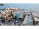 Aerial view of condos near the beach, parking, and beachside activities at 12924 Gulf Blvd # 502, Madeira Beach, FL 33708