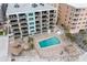 Overhead shot of condos featuring pool, tiki huts, and beach proximity at 12924 Gulf Blvd # 502, Madeira Beach, FL 33708