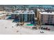 Aerial view of the beachfront condominiums with a pool area and beach access for residents at 12924 Gulf Blvd # 502, Madeira Beach, FL 33708