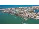 Aerial view of waterfront town with docks, boats, piers, colorful buildings, and picturesque views at 12924 Gulf Blvd # 502, Madeira Beach, FL 33708