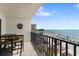 Breathtaking view from the private balcony with ample seating and a tropical decorative accent at 12924 Gulf Blvd # 502, Madeira Beach, FL 33708