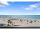 Expansive beach view with white sand and turquoise water, perfect for relaxation and recreation at 12924 Gulf Blvd # 502, Madeira Beach, FL 33708