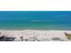 Picturesque aerial view of a serene beach with calm turquoise water and palm trees at 12924 Gulf Blvd # 502, Madeira Beach, FL 33708